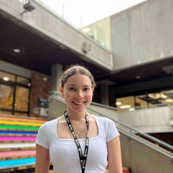Chaitanya Zeman Image Chaitanya Zeman standing in front of Auchmuty library steps and smiling.