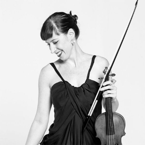 A person in a black dress holding a violin and bow