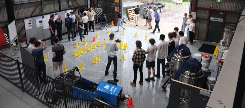 People gather in a large shed