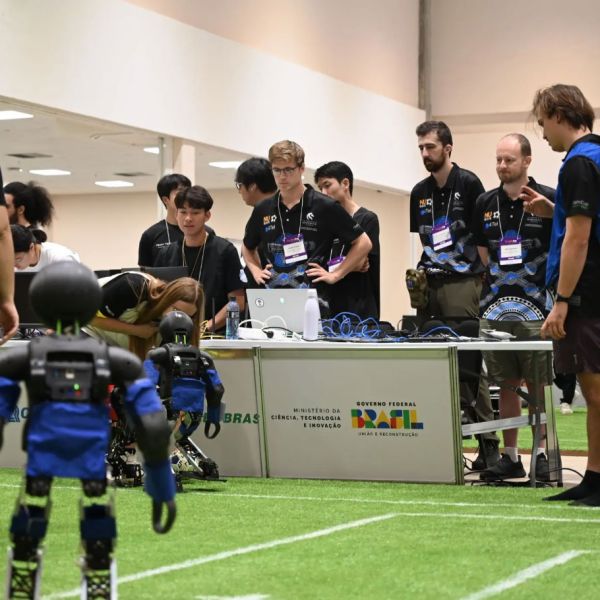 NUbots team members stand together, watching their robots. NUbots Claim Bronze at RoboCup 2025 | A Historic Finish in Brazil