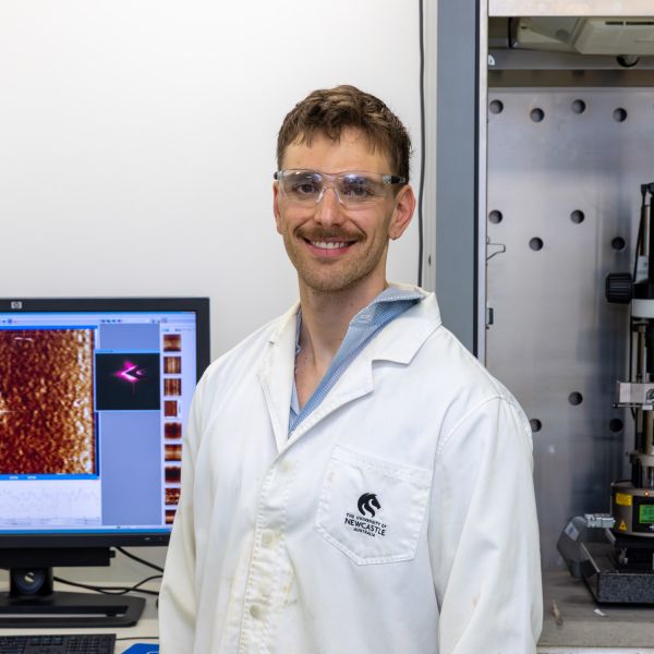 Zachary Di Pietro in a lab smiling at the camera