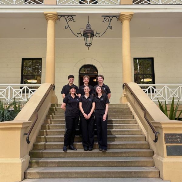 six students stand together on the steps of NSW Parliament House. University showcases achievements at NSW Parliament