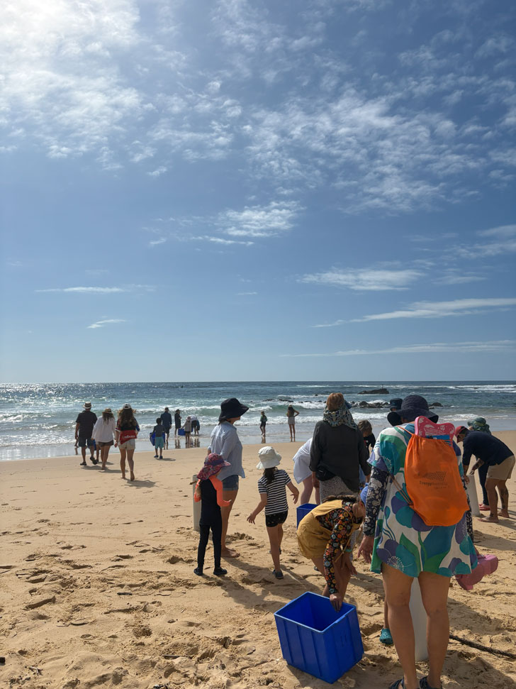 Community members standing on the beach