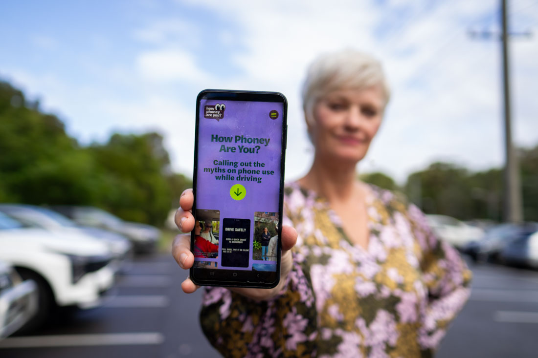 researcher holds up phone screen showing web intervention