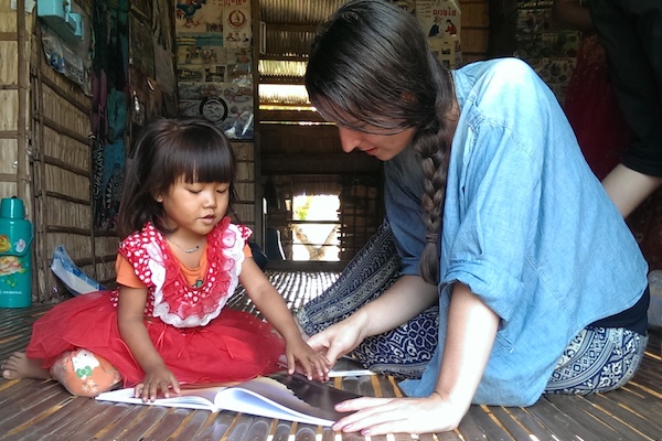 Kelsie helping a child in Cambodia