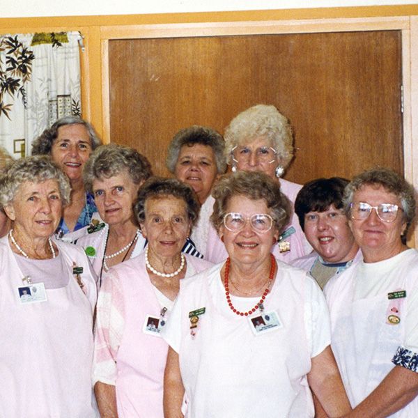 A group of female hospital volunteers wearing pink uniforms posing together at the Royal Newcastle Hospital, NSW, circa 1998.