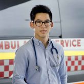 Medical student in front of an ambulance