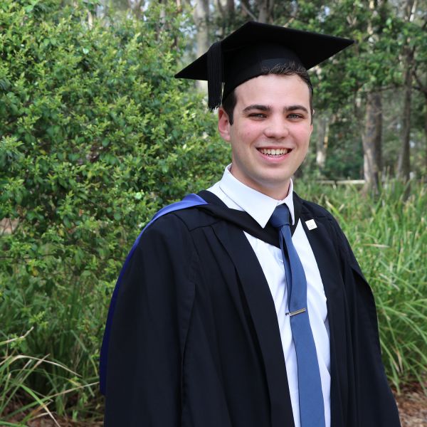 Declan Clausen graduating. Deputy Lord Mayor of Newcastle graduates with a tick of approval