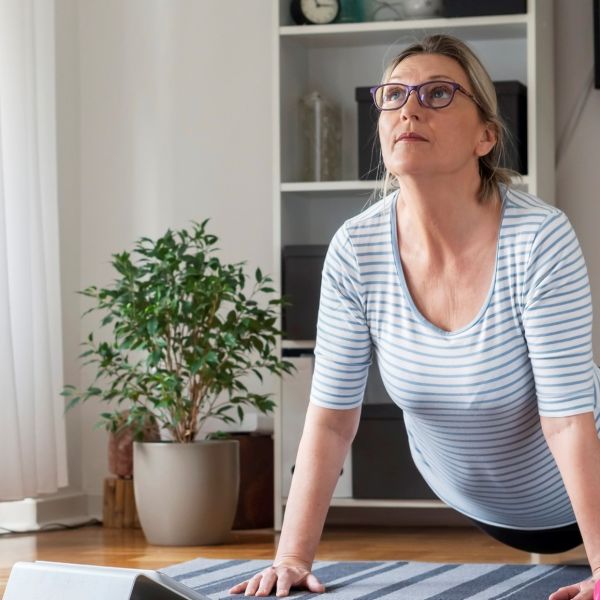 Woman doing yoga. Free fitness programs help graduates cross the finish line.