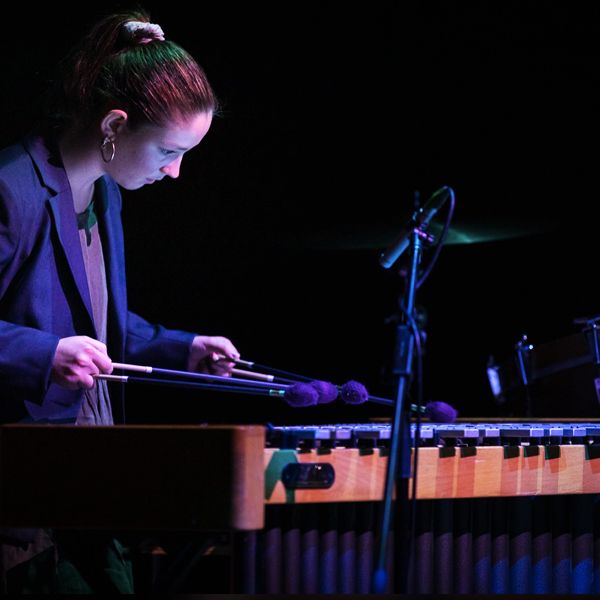 Image of individual female student playing the marimba