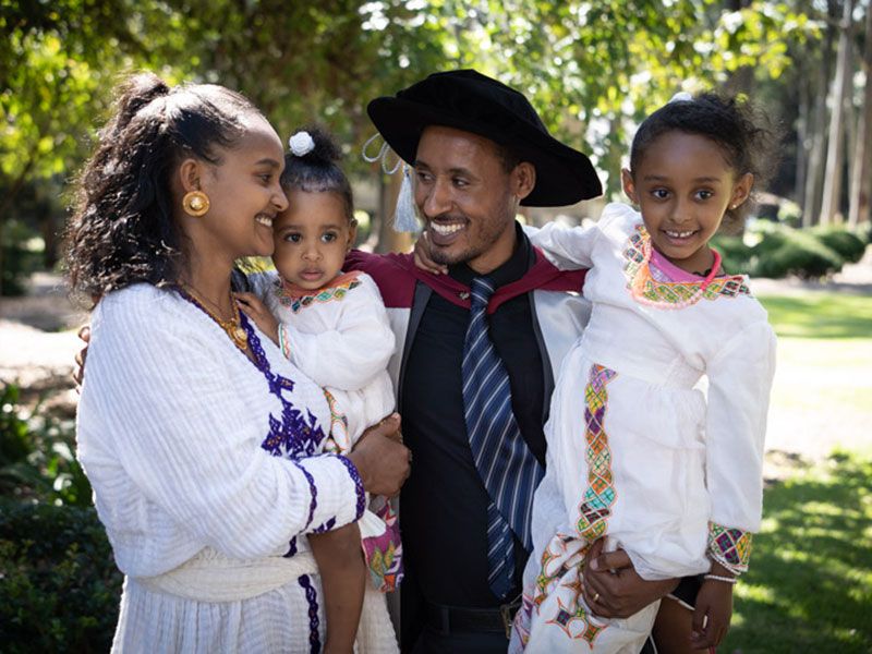 Teketo Tegegne celebrates his graduation with wife Aynwaga and daughters Hana, 5 and Tsion, 17 months.