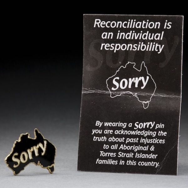 Photograph of a 'Sorry' badge and card