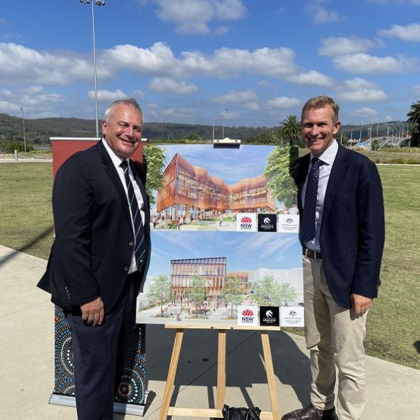 Vice Chancellor Professor Alex Zelinsky and Minister Stokes stand with a rendered image of the new building