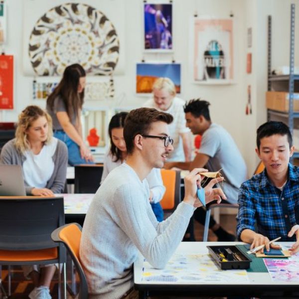 Students discussing in a classroom. National University Teaching Awards recognise outstanding University of Newcastle educators 
