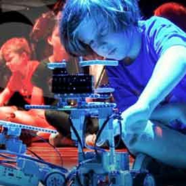 Young boy playing with a robot