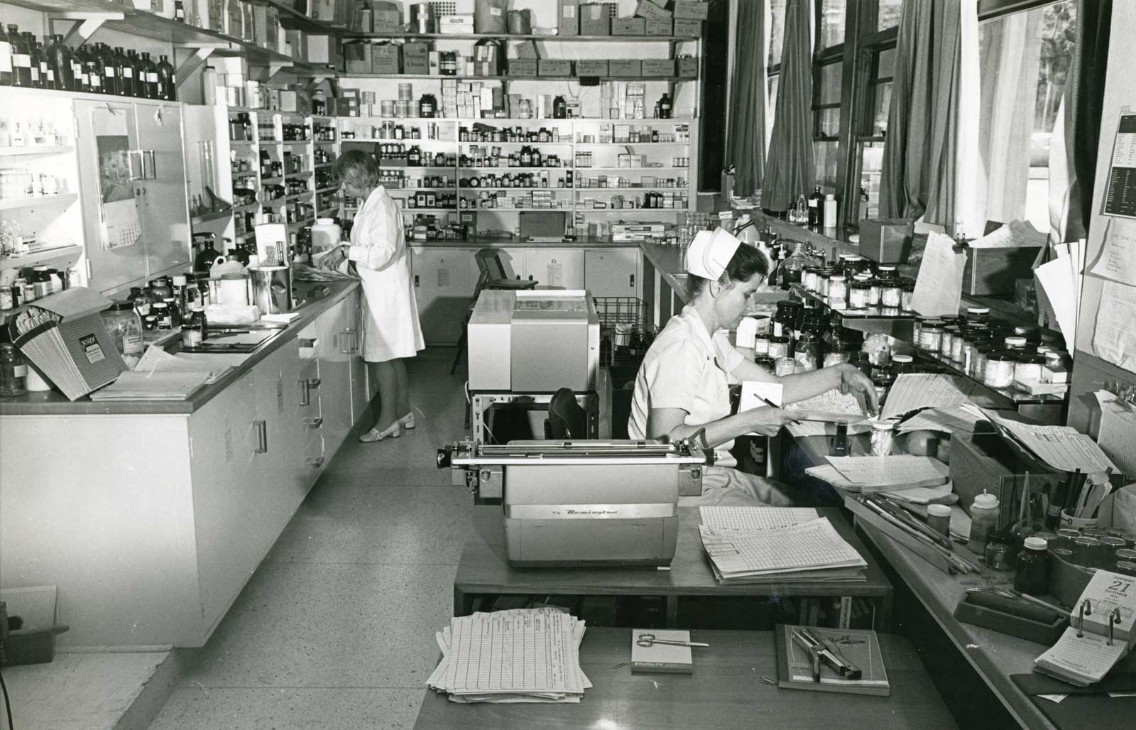Janice worked closely with nurses and hospital staff, like those shown here, while at the Royal Newcastle Hospital. Undated photo from Living Histories - livinghistories.newcastle.edu.au historic image of two women in nursing outfits in a hospital dispensary