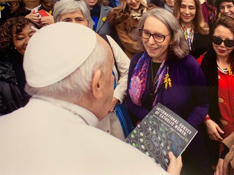 Dr Tracy McEwan hands Pope Francis a copy of the International Survey of Catholic Women (c) Vatican Media