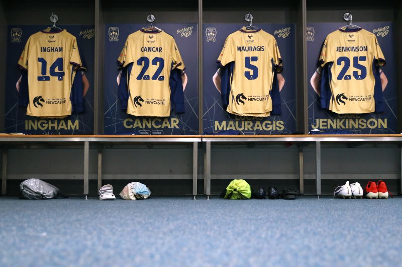 Jets game shirts hanging in locker room