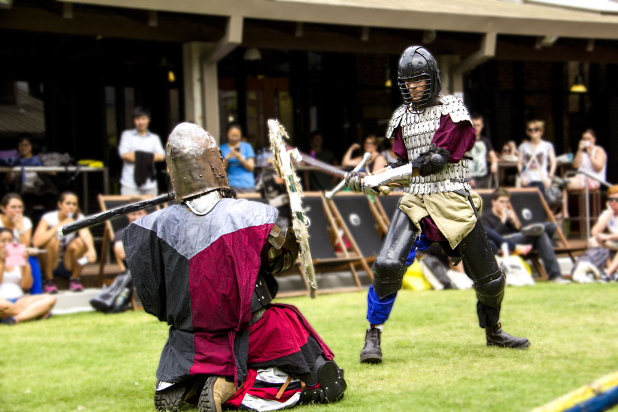 The Medieval Society members dressed in medieval attire and fighting with swords