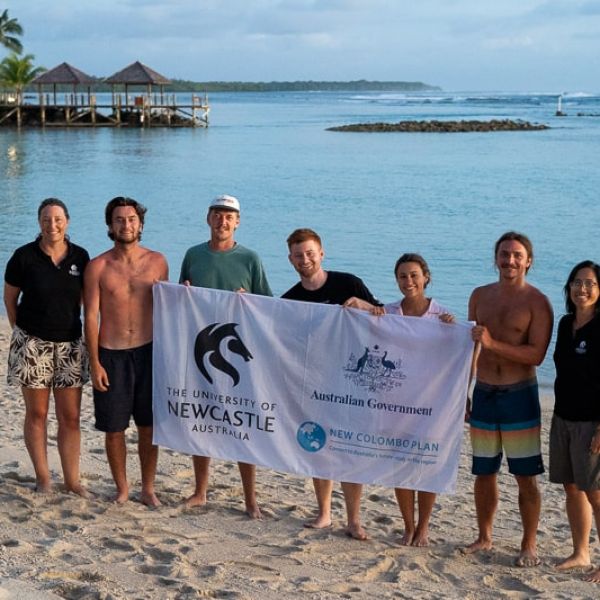 Group shot on a beach at sunset
