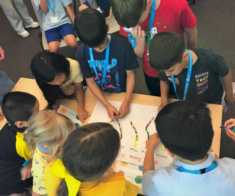 Children in group making beads