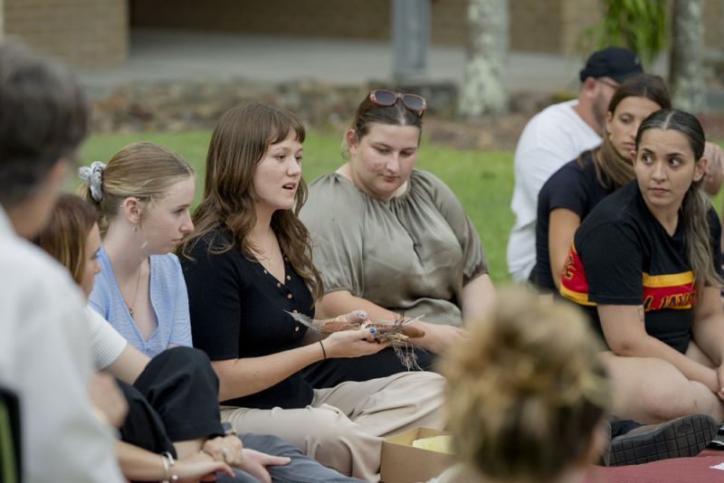 A group of students sitting on the ground together