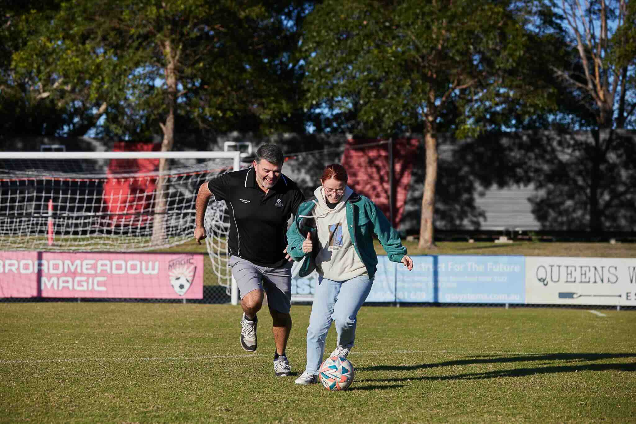 Ellie and her dad Brad play soccer