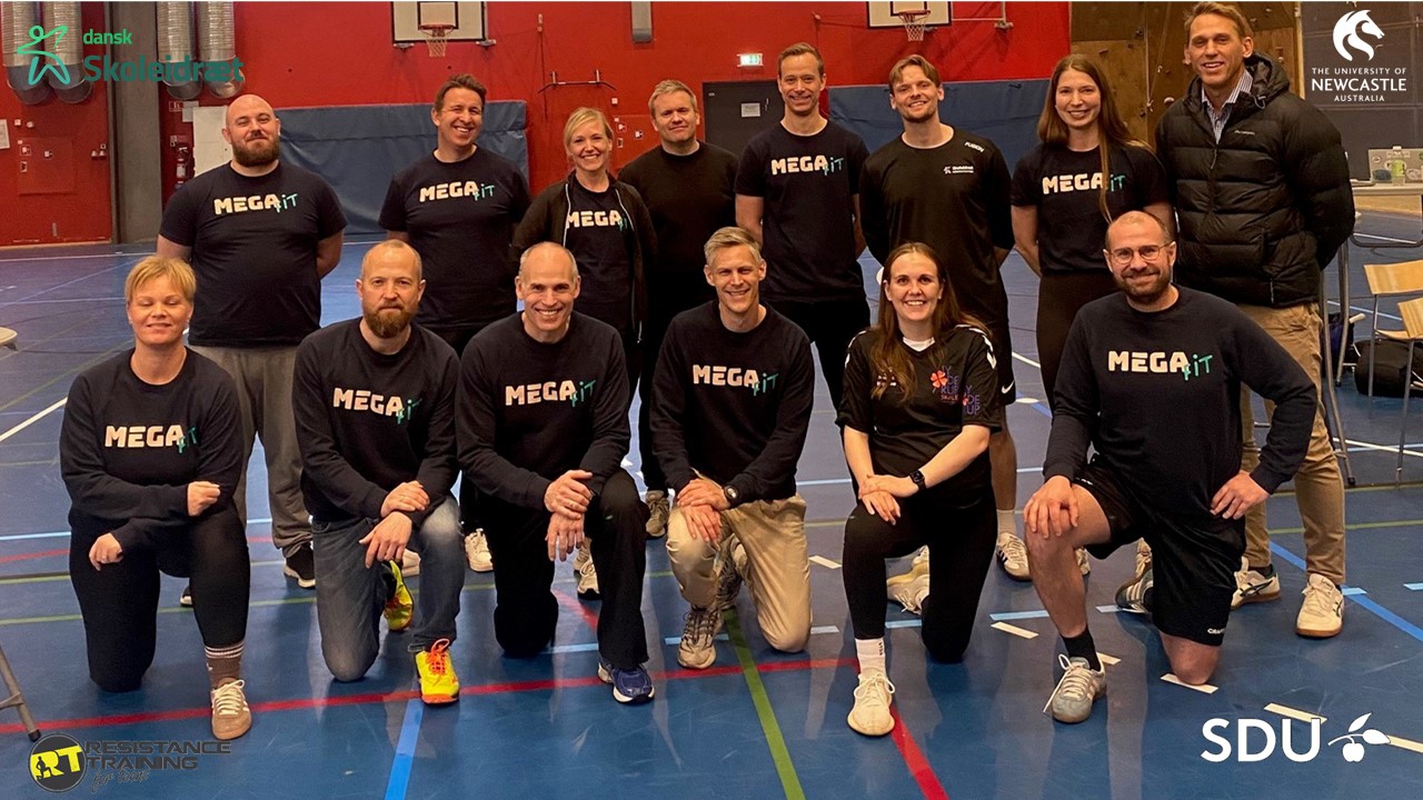 A group of people posing on a sporting court