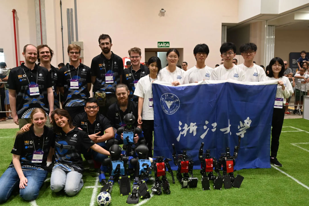 NUbots team stand alongside competitors