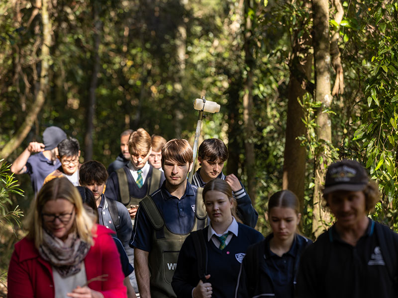 Students and staff walk through the bush