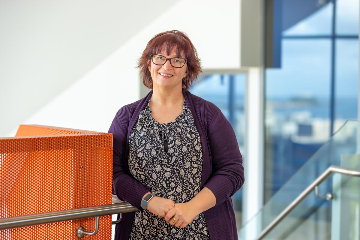 Caitlin smiling at camera in Newcastle Business School NUSpace building 