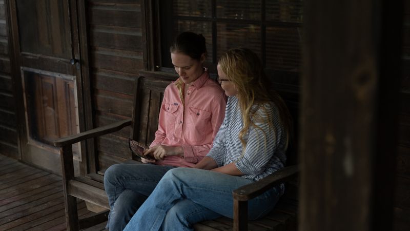 Sophie and Hedda look at Sophie's old photos of the farm