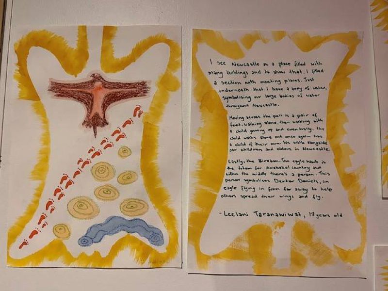 outline of pospaisum skin with eagle and footsteps painted inside. An interpretation in words about Newcastle sits alongside