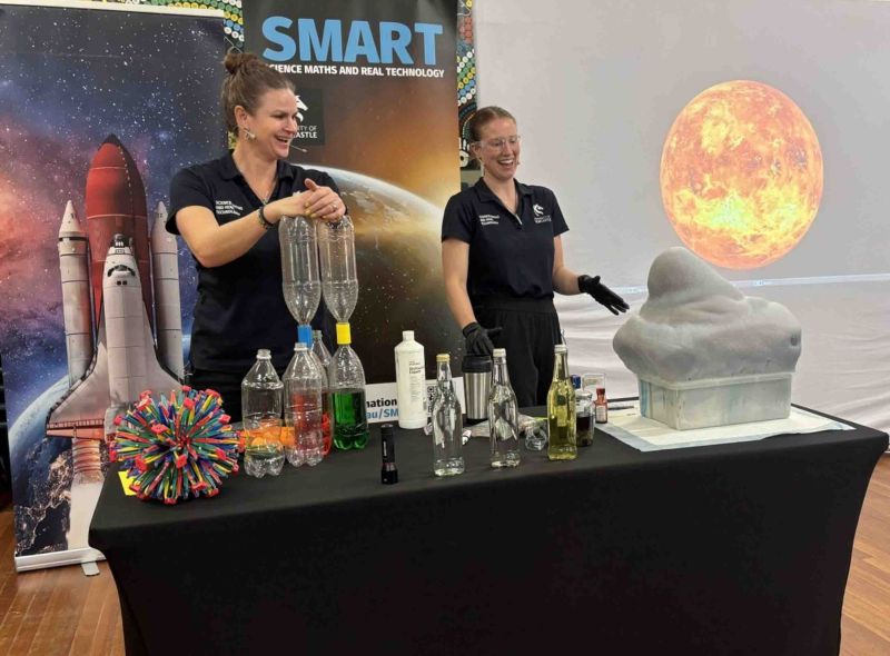 2 hosts doing elephants toothpaste science experiment
