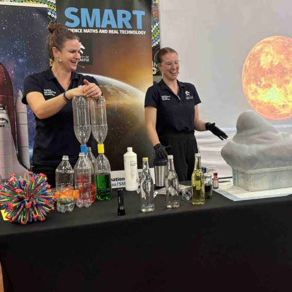 2 hosts doing elephants toothpaste science experiment