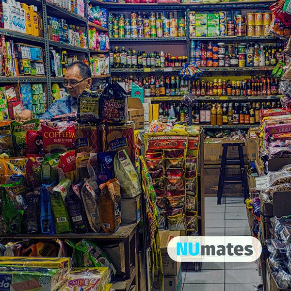 image of man sitting at counter in Asian grocery store
