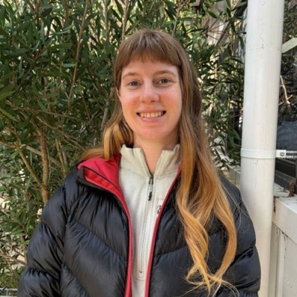 Student, Phoebe Carter-Swain, smiling and looking at the camera, pictured outside with greenery in the background.. Staying the course through cost pressures.