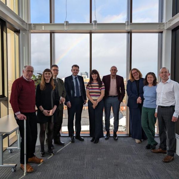 A group of people standing in an office