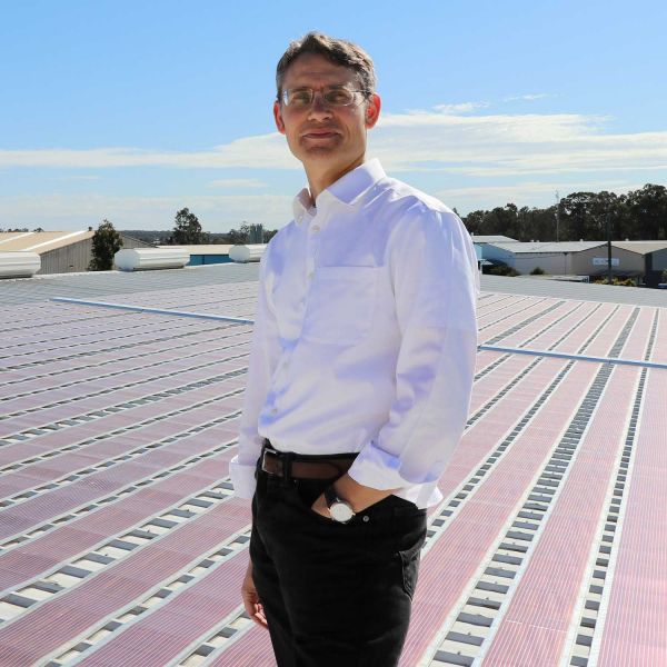 Professor Paul Dastoor with solar field. Electric partnership powers energy innovation