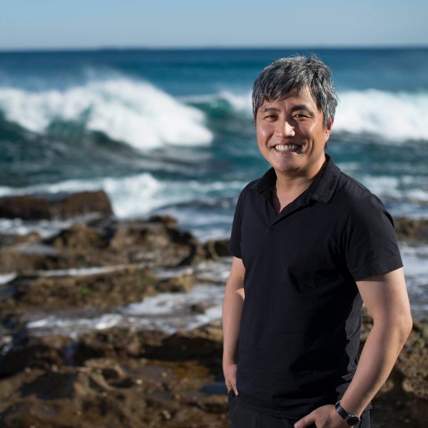 researcher standing by water. Newcastle researcher making a mark with a NASA satellite mission