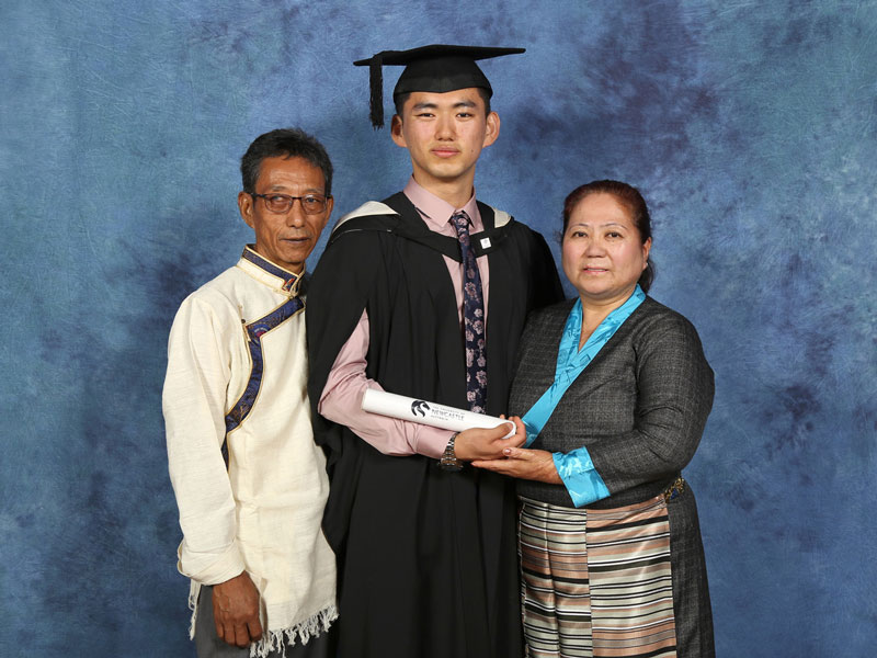 Tenzin and his parents at his graduation ceremony