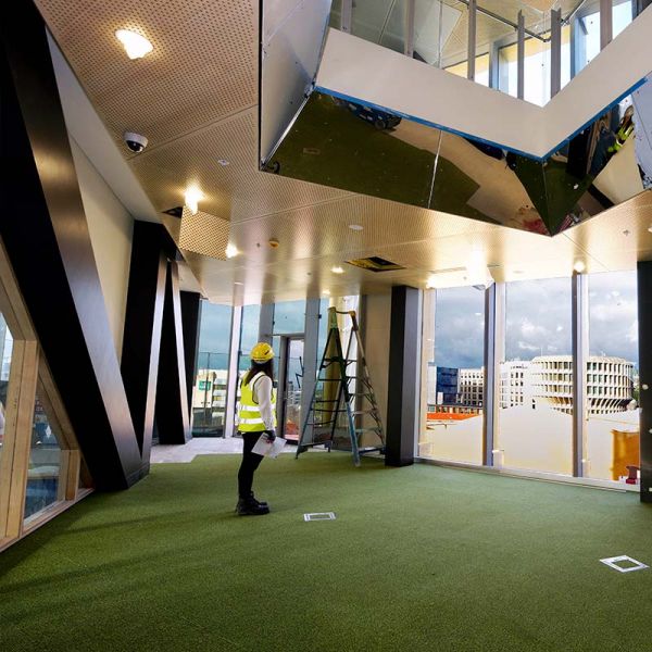Woman standing in a room under construction
