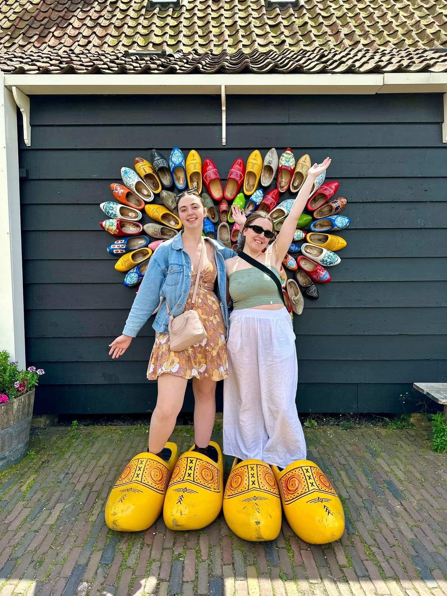 Two girls in front of a clog display in the Netherlands