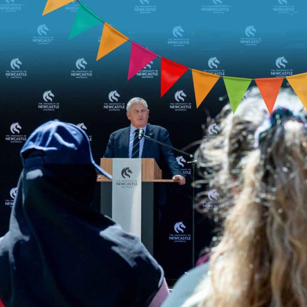 Vice-Chancellor's Student Welcome Vice-Chancellor Alex Zilensky standing behind a podium with a microphone, Welcoming students to the University of Newcastle.