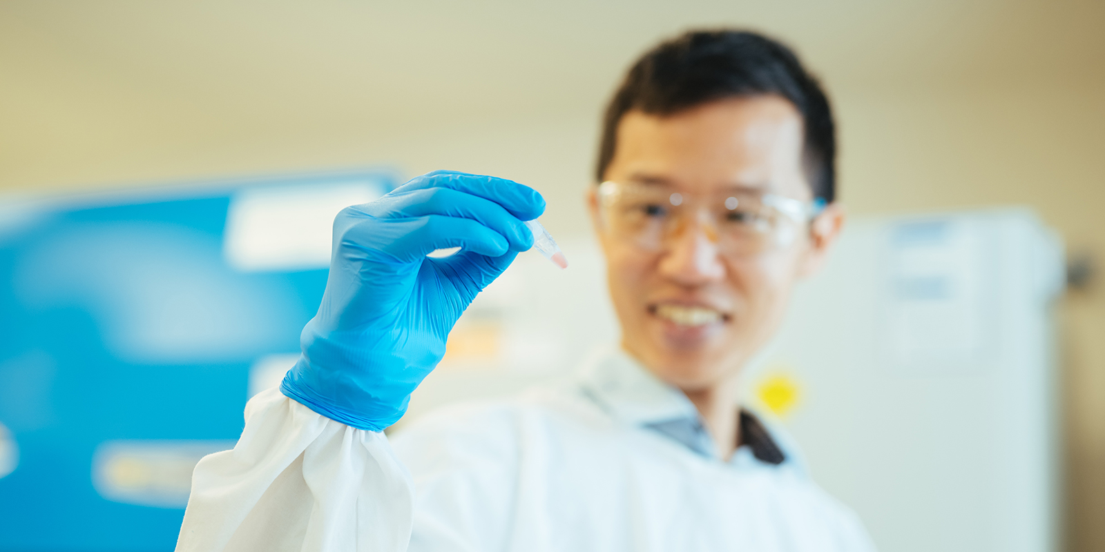 A man looking at a small virus