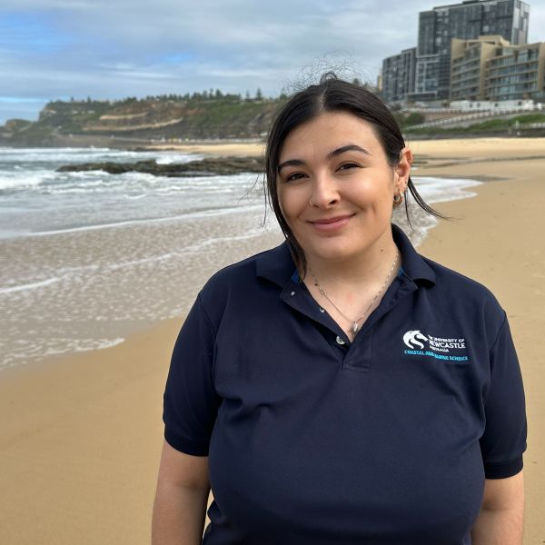 University of Newcastle PhD student Molly Grew standing on the beach. Scientists unearth stingrays’ heavy lifting role in estuaries.