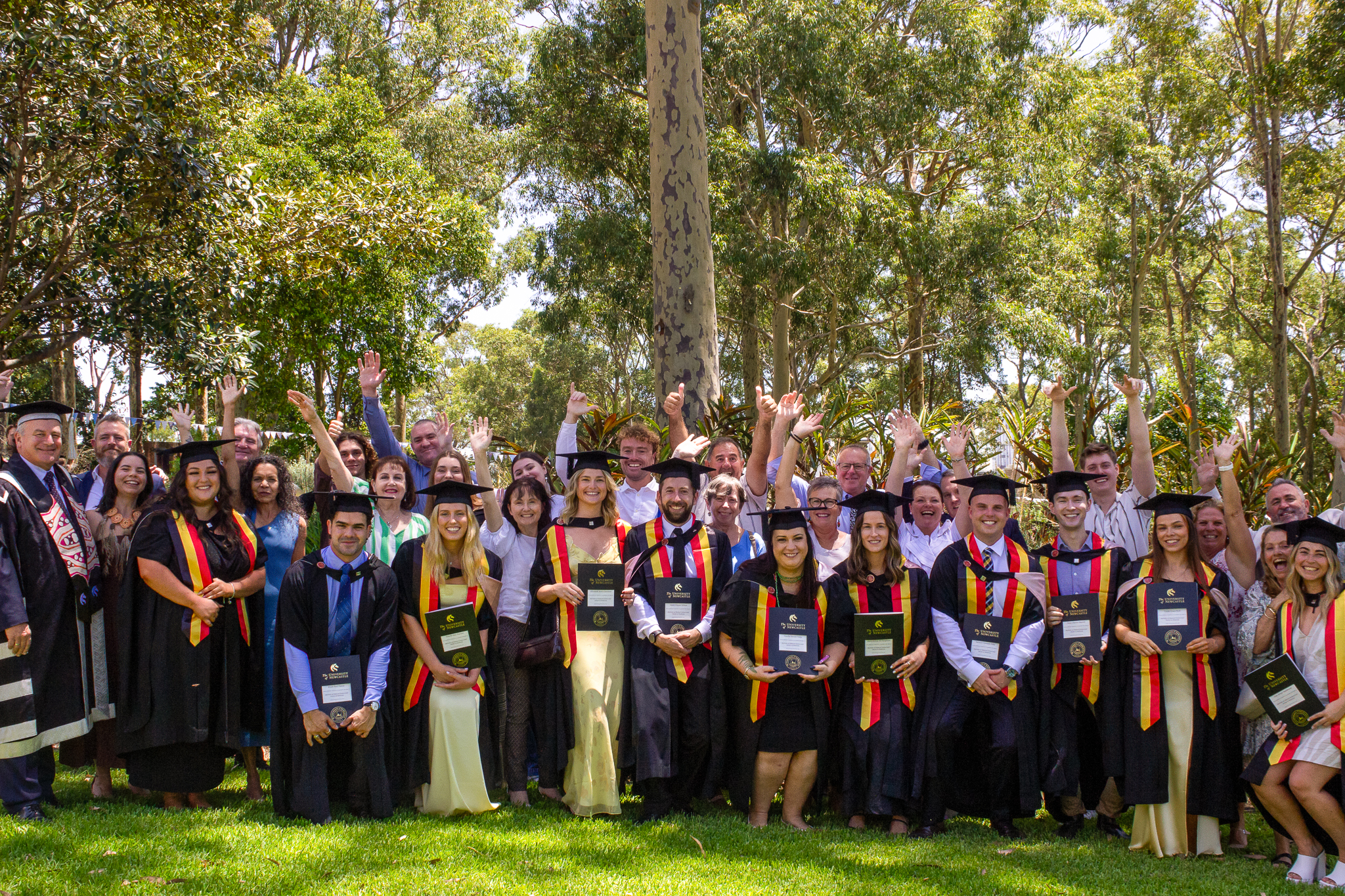 Group of graduating Indigenous doctors with their families and the Vice Chancellor Alex Zelinsky