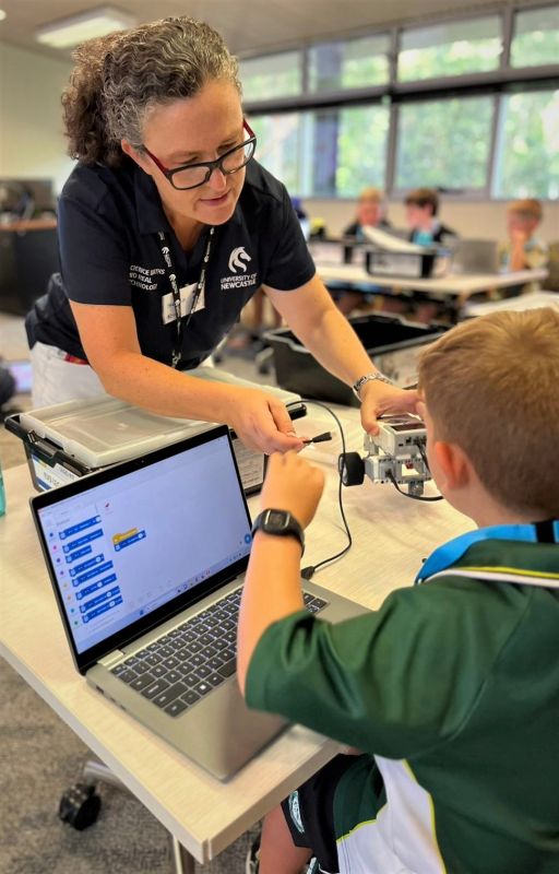 Sonia assisting student with coding