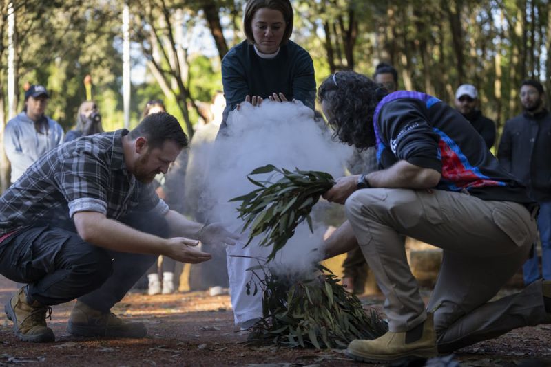 A small group of people during a smoke ceremony