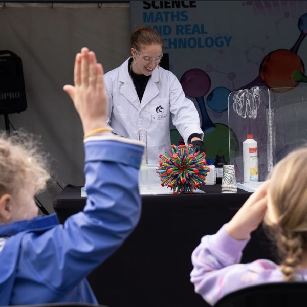 A student leads an interactive science exhibition